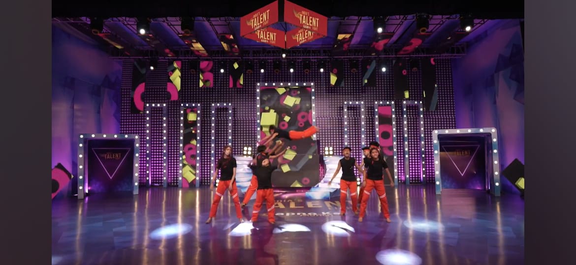 Grand stage aerial flip performance with hanging 3D ITF logos